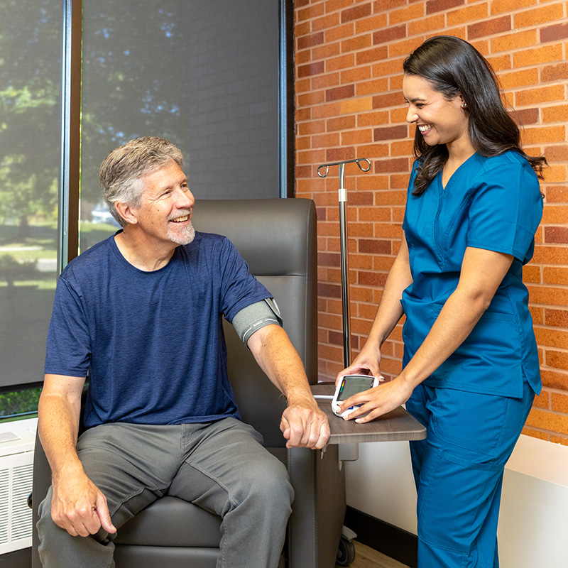 PerCuro nurse checking on a patient during treatment