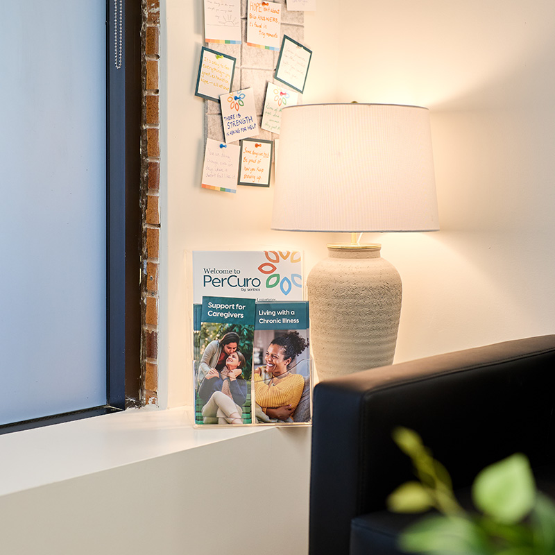 Warm PerCuro clinic corner with welcome brochure